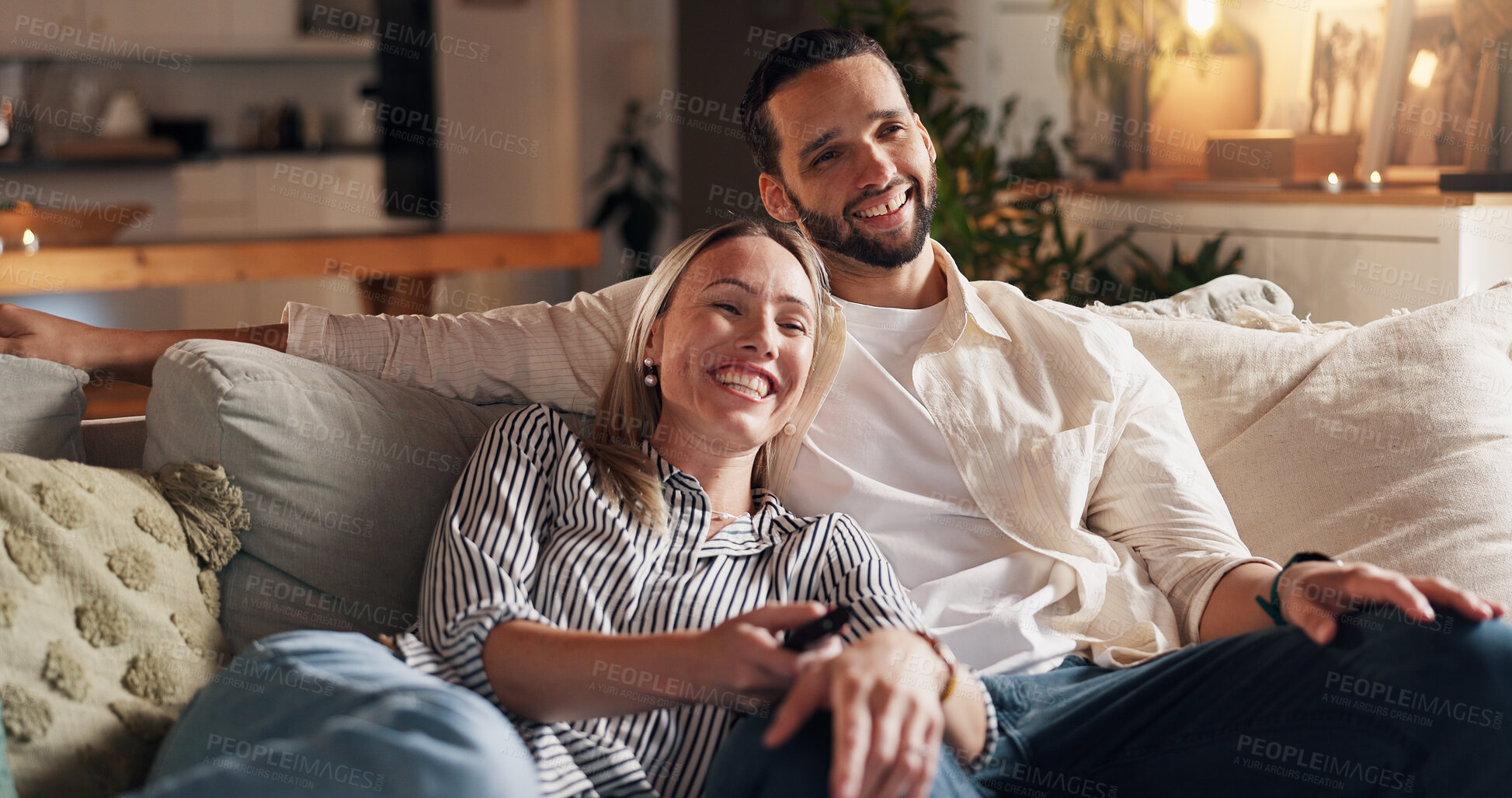 Buy stock photo Couple, relax and watching tv on sofa, happy and home with streaming, film or love with bonding in lounge. People, woman and man with remote control on couch for movies, smile and show in living room