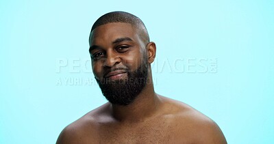 Buy stock photo Black man, portrait and confident in studio for skincare, face and grooming in morning. African person, dermatology and smile on blue background space for beard care, topless and hygiene in Nigeria