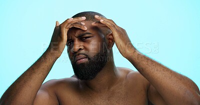 Buy stock photo Worry, face check and skincare for man, portrait and acne treatment in morning, serious and dermatology. Blue background, self care and black person with routine for beauty, inspection and studio