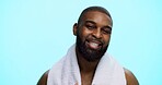 Black man, portrait and smile with towel in studio for natural beauty, beard and wellness on blue background. Shower, cosmetic or happy male person with facial hair, grooming or space for cleaning
