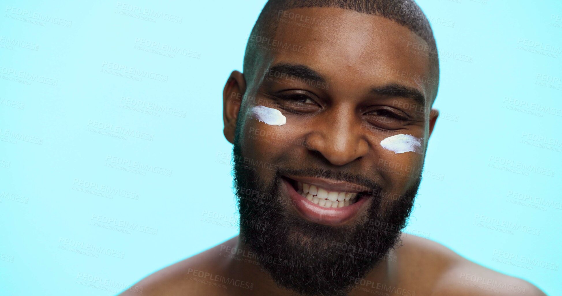 Buy stock photo Portrait, cream and black man with smile, skincare and facial spf with glow on blue studio background. African person, space or model with shine, creme or lotion with moisturizer, beauty or aesthetic
