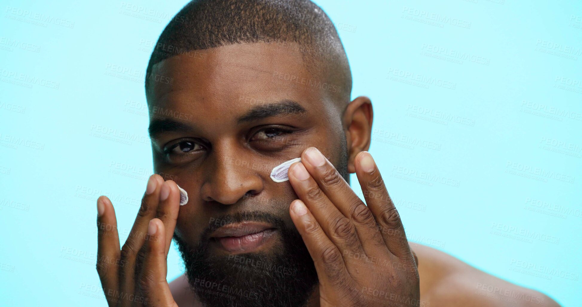 Buy stock photo Portrait, cream and black man with skincare, dermatology and facial spf on blue studio background. African person, space and model with shine, creme or lotion with moisturizer, glowing and aesthetic