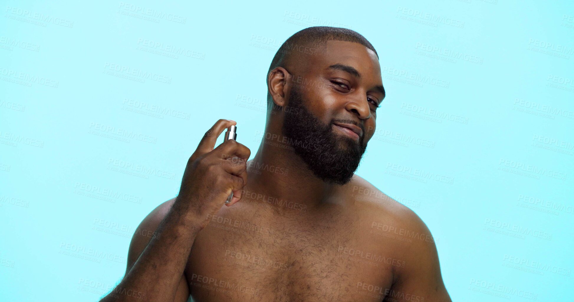 Buy stock photo Black man, spray or cologne for hygiene in portrait, fragrance or grooming with cosmetic product on blue background. Studio, perfume or spritz for scent, male person and self care with wellness space