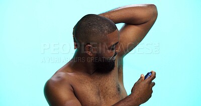 Buy stock photo Black man, spray or deodorant for armpit with hygiene in studio, fragrance or grooming with cosmetic product. Underarm smell, perfume or spritz for scent, male person and self care on blue background