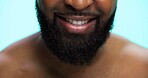 Beard, grooming and mouth of black man on blue background for morning skincare routine. Beauty, masculinity and self care with person closeup in studio for personal hygiene, relax or wellness