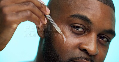 Buy stock photo Portrait, serum or black man in studio, cosmetics or dermatology on blue background. African person, essential oil or model with dropper, hyaluronic acid or skincare with collagen, glow or anti aging