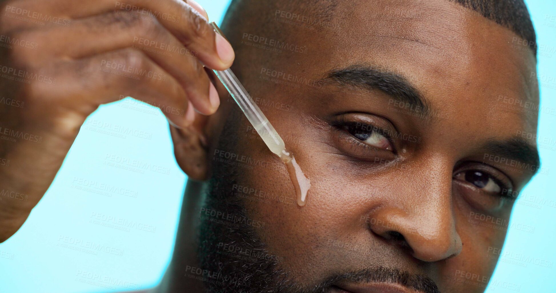 Buy stock photo Portrait, serum or black man in studio, cosmetics or dermatology on blue background. African person, essential oil or model with dropper, hyaluronic acid or skincare with collagen, glow or anti aging