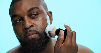 Buy stock photo Brush, foam and shaving with black man in studio, cosmetic care and product with skincare on blue background. Space, cream or facial maintenance for hair removal, beauty or grooming for hygiene