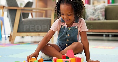 Buy stock photo Black girl, block and building with toys for playing or fun activity on floor at therapy office. Kid, child or student with shapes or assessment for playful learning, fine motor skills or education