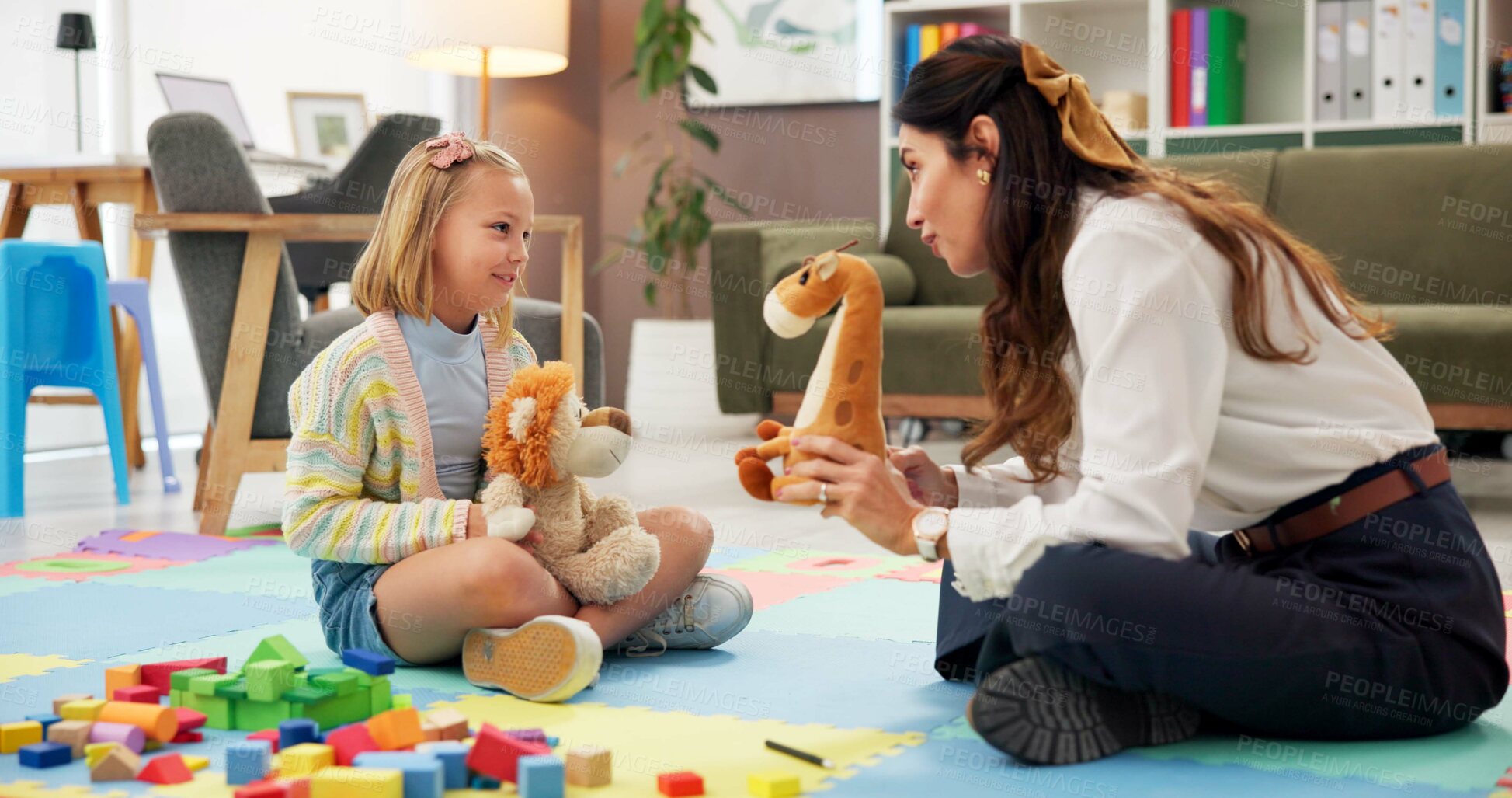 Buy stock photo Therapy, woman and girl with toys, talk and listen with guide for emotional assessment on floor. Person, psychologist and child with dolls, playful and consulting for test at mental health clinic