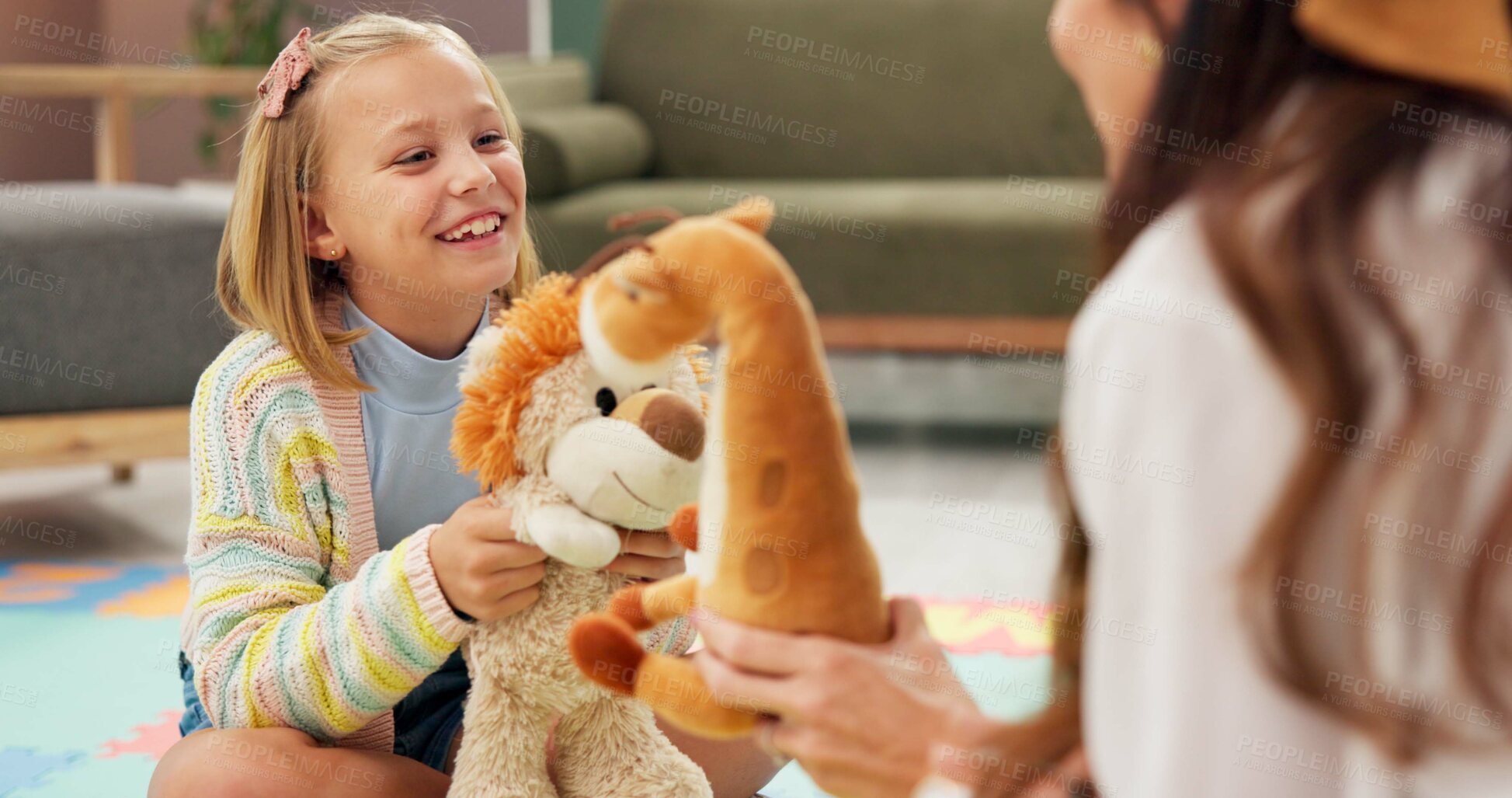 Buy stock photo Therapy, woman and girl with toys, consulting and listen with smile for emotional assessment on floor. Person, psychologist and child with dolls, evaluation and talk for test at mental health clinic