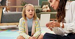 Woman, girl and psychology with card for evaluation with talk, guide and emotional assessment on floor. Therapy, child and paper with consultation, test and exam for help with mental health at clinic