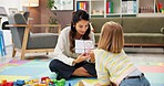 Woman, teacher and child in classroom with visual lesson for private tutoring or assessment at elementary school. Female person, educator or academic therapist with pictures for childhood development