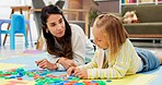 Therapist, child and letters toys in office for mental health, examination or progress. Psychologist woman, pediatrics and girl for wellness, clinic or consultation for patient support or development