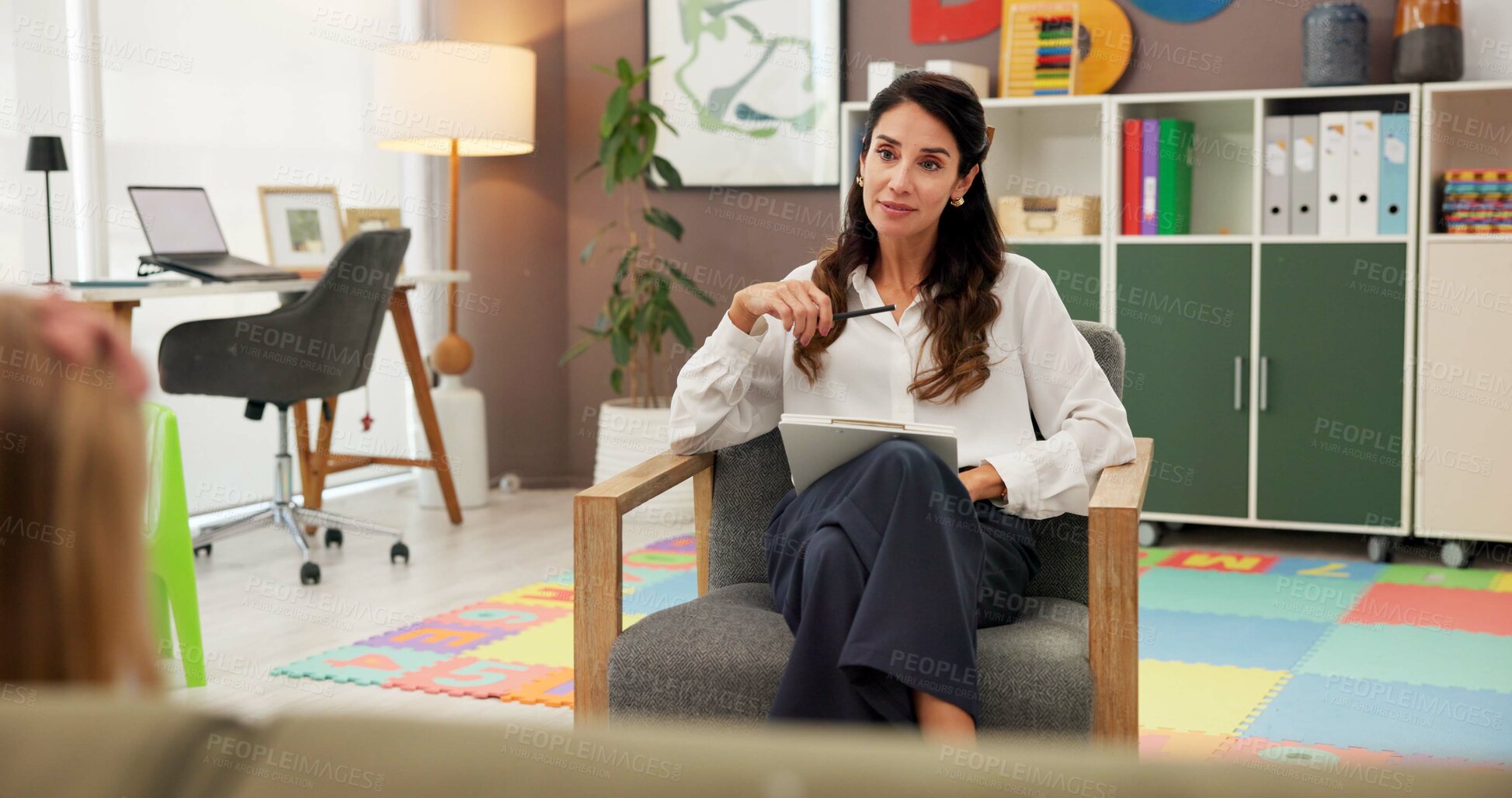 Buy stock photo Psychology, woman and clipboard with child, talk and happy with notes for emotional assessment at clinic. Person, therapist and kid with checklist, question and listen with test for mental health