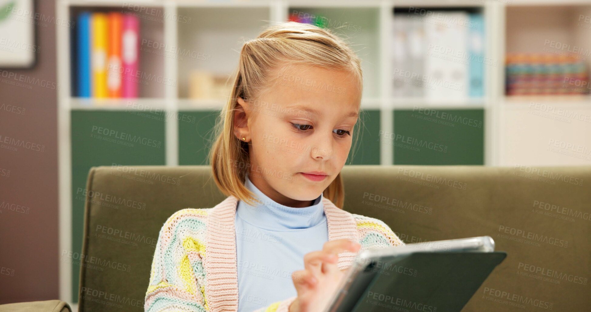 Buy stock photo Girl, reading or sofa with tablet for elearning, education or lesson at private elementary school. Child, kid or student with technology or app on couch for childhood development, ebook or story time