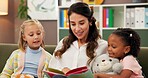 Happy woman, teacher or reading book with children for education, learning or story time at elementary school. Female person, educator or novel with kids or students for fun lesson or private class