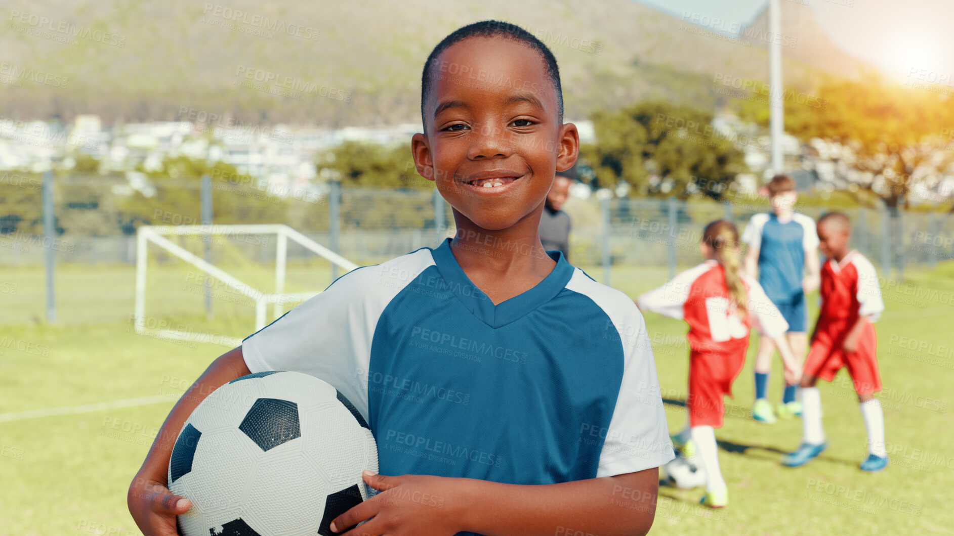 Buy stock photo Boy, portrait and training with smile, soccer and ball with pride, learning or outdoor for development. Child, excited and football team with goals, exercise and happy with fitness on grass field