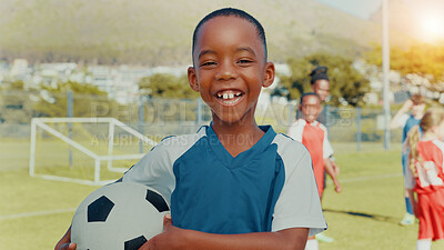 Buy stock photo Child, portrait and training with smile, soccer and ball with pride, learning or outdoor for development. Boy, excited and football team with goals, exercise and happy with fitness on grass field