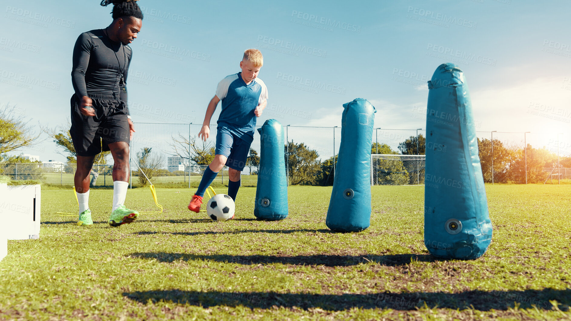 Buy stock photo Training, coach and child with ball, sports field and performance with energy in morning, cardio or kick. Playing, football and kid with sportswear for game, growth or development of boy with fitness