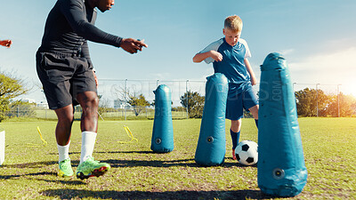 Buy stock photo Coach, playing and child with ball, sports field and performance with energy in morning, cardio or kick. Training, football and kid with sportswear for game, growth or development of boy with fitness