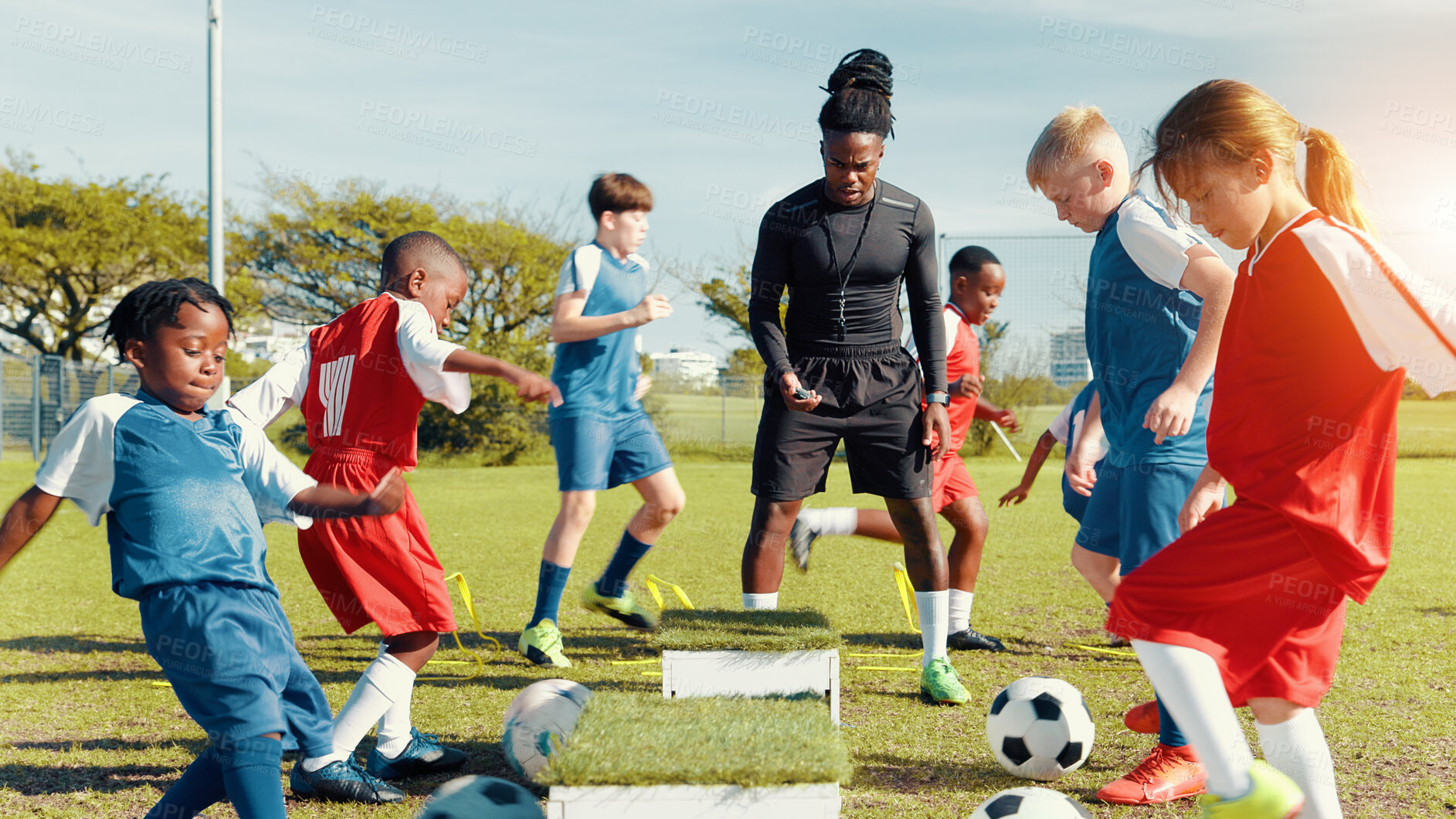 Buy stock photo Sports field, soccer player and children with ball, training and athlete with energy for practice in morning. Playing, football and kids with sportswear for game, growth and development with fitness