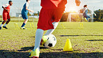 Soccer player, feet and children with ball, kick and athlete with energy for practice, cardio and legs. Playing, football and kids with sportswear for game, growth and development with fitness