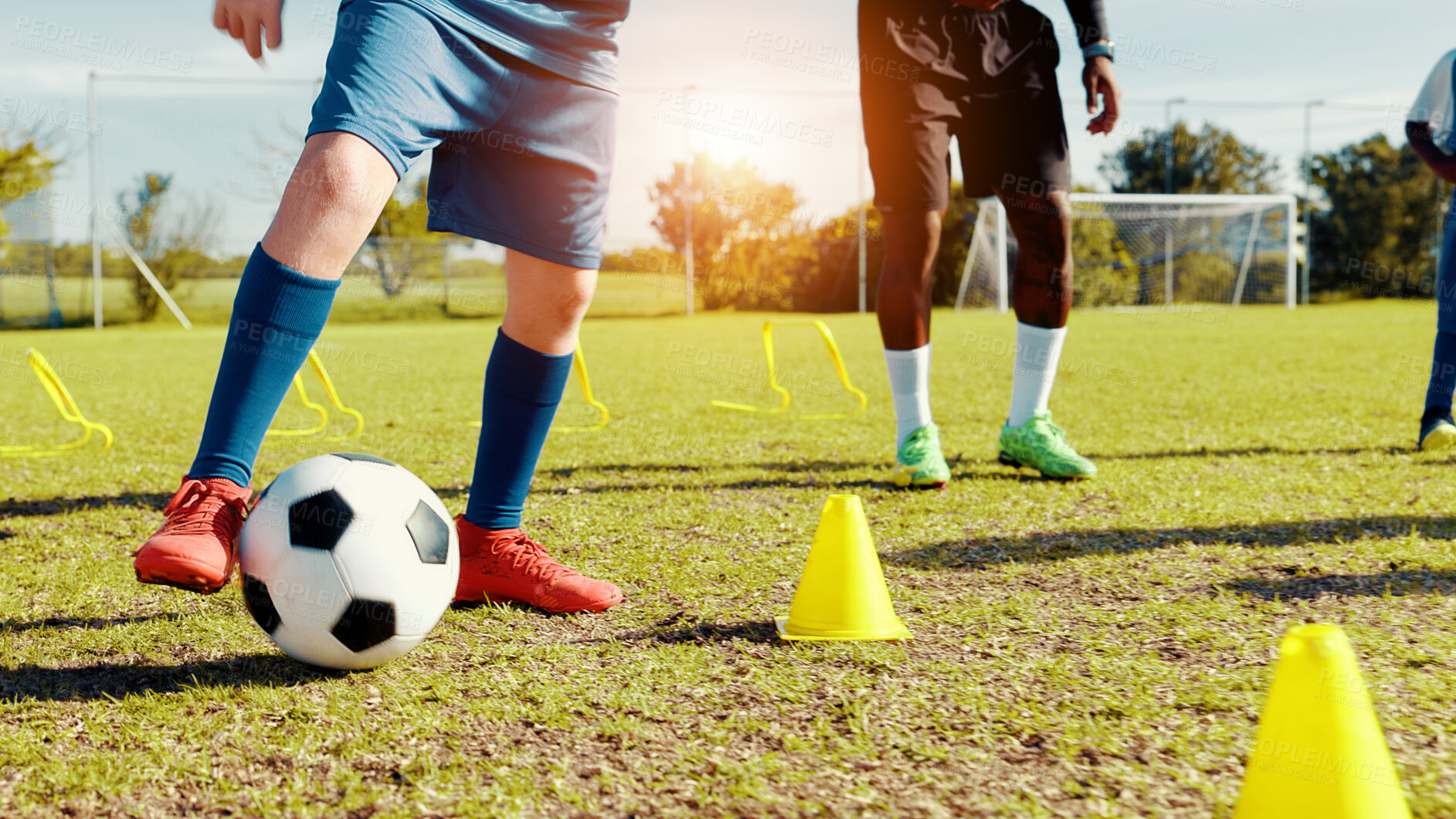 Buy stock photo Sports field, legs and children with ball, kick and athlete with coach for practice in morning or cardio. Playing, football and kids with sportswear for game, growth and development with fitness