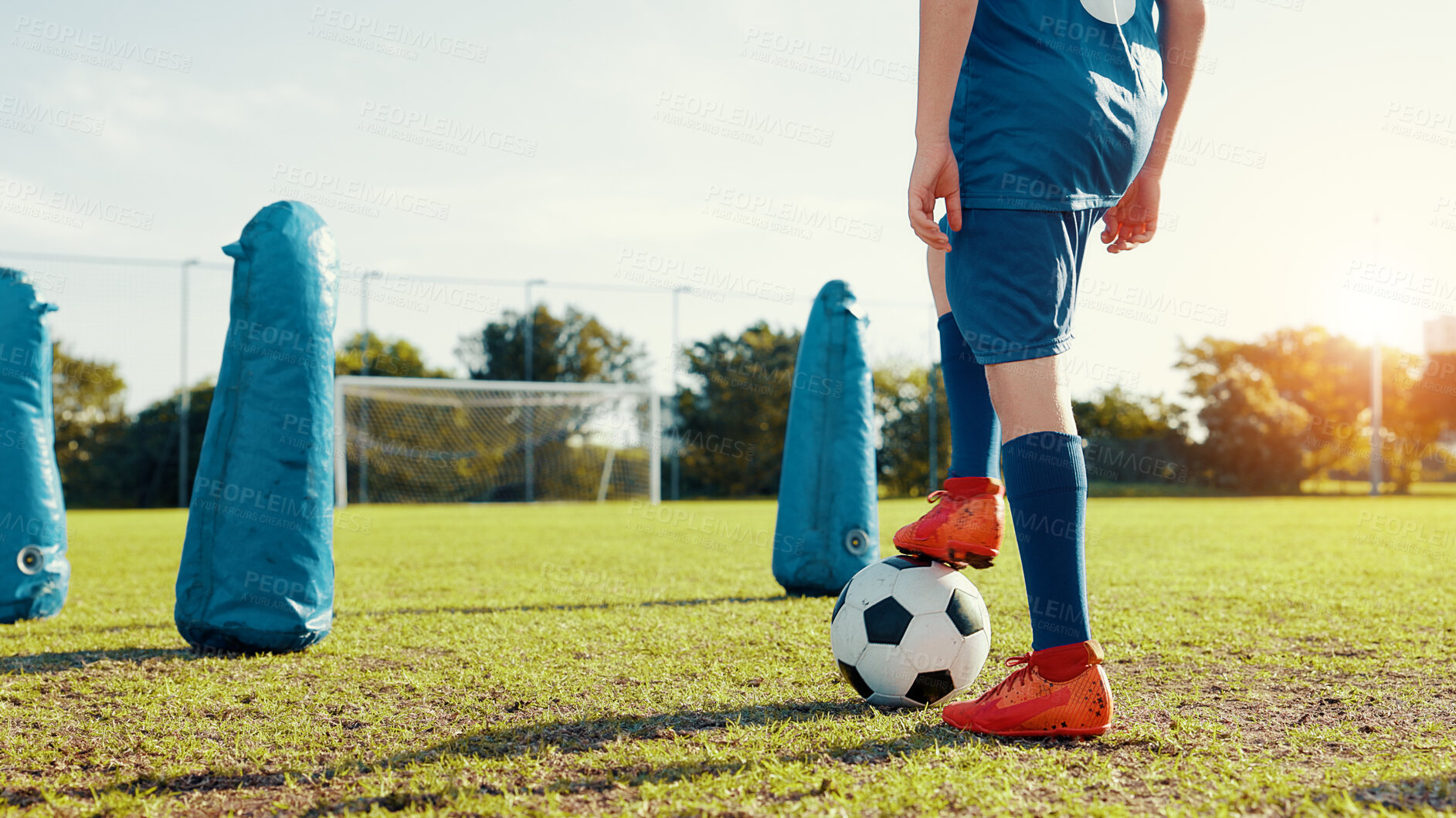 Buy stock photo Sports field, active and child with ball, feet and athlete with energy for practice in morning. Soccer player, football and kids with sportswear for game, growth and development with fitness and legs