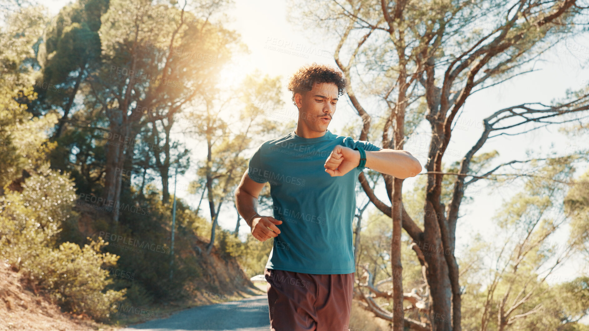 Buy stock photo Fitness, running and watch with man outdoor on road in forest for cardio, challenge or performance. Exercise, time and tracking with athlete or runner in nature for sports, training or workout