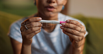 Buy stock photo Hands, pregnancy test and woman on sofa in living room of home, waiting for fertility results. IVF, kit and nervous with person closeup in apartment for family planning, motherhood or parenting