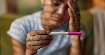 Buy stock photo Hands, pregnancy test and regret with woman on sofa in living room of home, waiting for fertility results. IVF fail, kit and stress with person closeup in apartment for crisis, disaster or mistake