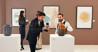 Buy stock photo Art gallery, picture and man in museum with phone for social media, online post and creative blog. Auction, exhibition and person photograph ceramic vase for research, artwork information and review