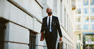 Buy stock photo Businessman, lawyer and walking with briefcase in city for corporate travel, law or job opportunity. Man, employee or attorney with folder or bag for court case or legal advice in an urban town