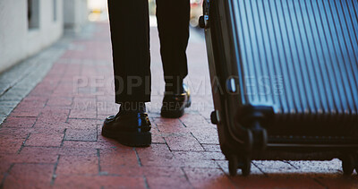 Business person, legs or walking with suitcase in city for corporate travel, destination or commute. Closeup, immigrant or shoes with luggage for job, career opportunity or work trip in an urban town