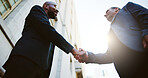 Below, business people or men in city, handshake or partnership with b2b deal. Low angle, employees or outdoor with introduction, onboarding or welcome with greeting, hello or agreement with contract