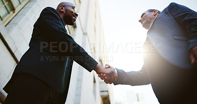 Buy stock photo Below, business people or men in city, handshake or partnership with B2B deal. Low angle, employees or outdoor with introduction, onboarding or welcome with greeting, hello or agreement with contract