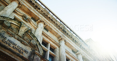 Buy stock photo Below, building and court for justice, law and judicial with traditional architecture for legal place. Landmark, structure and lens flare for legislation, litigation or magistrate low angle in city
