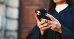 Cellphone, hands and businesswoman in city with communication, contact or email with legal client. Phone, research and closeup of female attorney with online networking for law case in urban town.