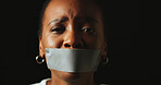 Woman, tape and mouth with stress in studio for silence, voice and anxiety ad by black background. African person, cover lips and portrait with depression, sad and mental health with space in Nigeria