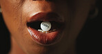 Mouth, tablet and addiction in studio closeup with text for mind altering drugs by black background. Person, pills and illegal medicine with opioid crisis, mood and happy with chemical compound