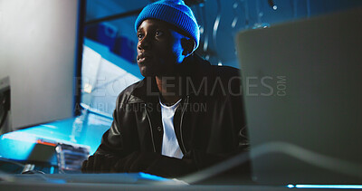 Buy stock photo Black man, hacker and reading on computer at night for programming, cyber attack and online information. Male person, pc and research for website phishing, data protection and criminal for fraud risk