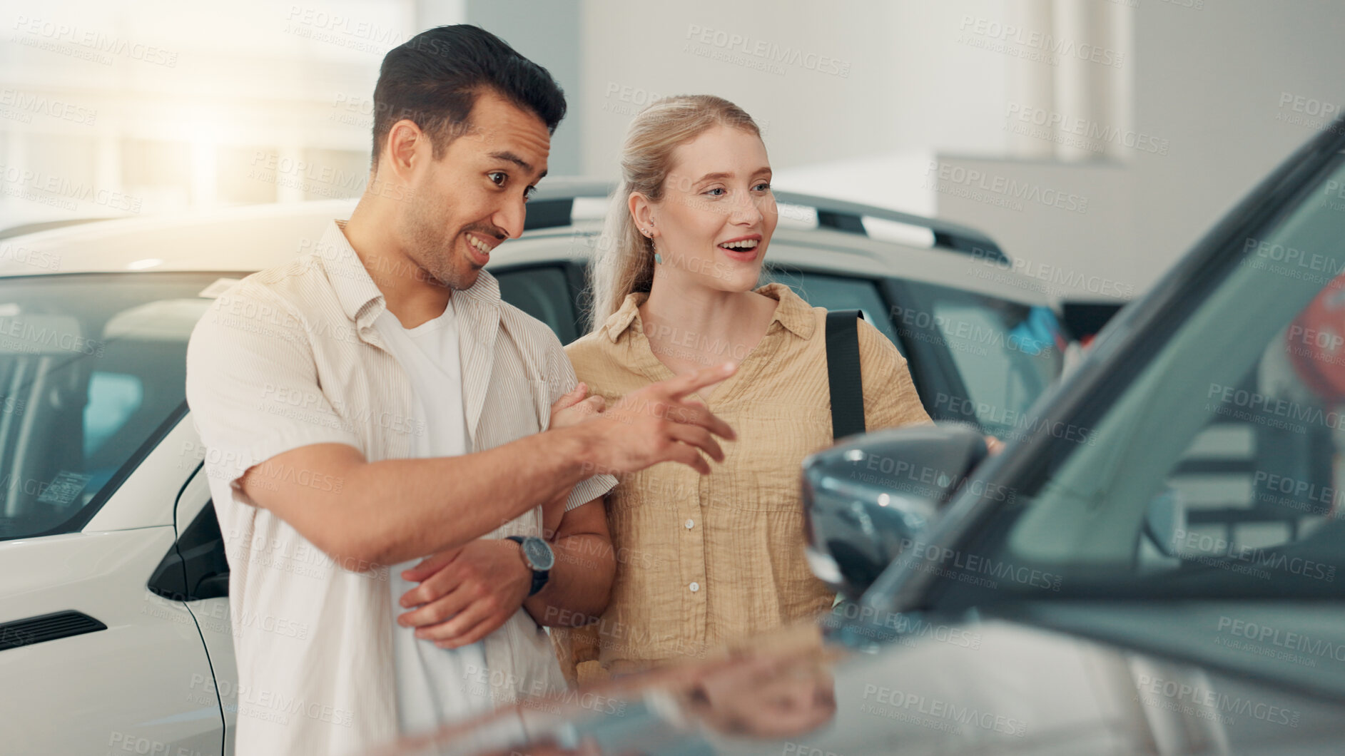 Buy stock photo Car, couple and smile with conversation in dealership, rental service and browsing for vehicle. Automobile shop, woman and man with pointing for transport features, investment or  talking in showroom