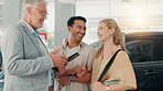 Excited, new car and couple in dealership with salesman, smile or investment in auto insurance. Broker, people and buyer in showroom shopping for vehicle finance, customer satisfaction or motor sales