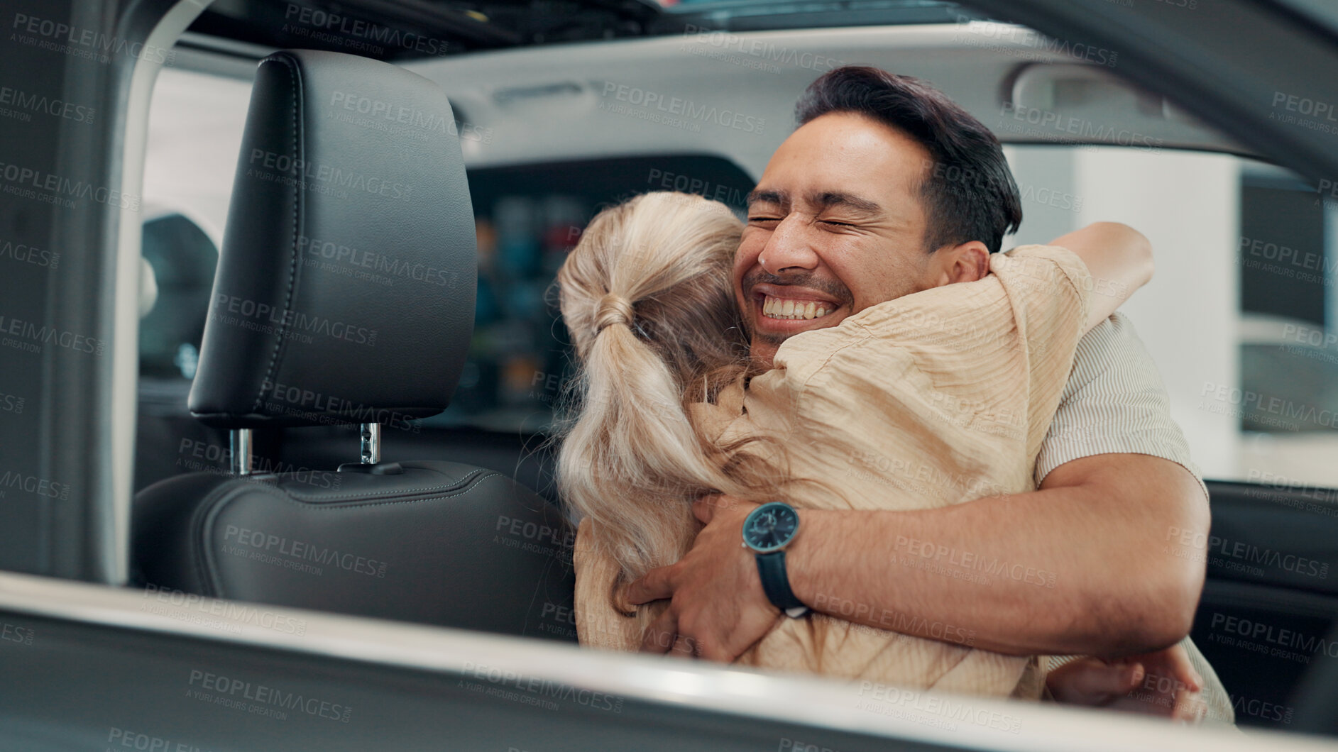 Buy stock photo Excited, new car or couple in showroom with hug, smile or investment in auto insurance. Purchase, happy people or buyer in dealership shopping for vehicle finance, customer satisfaction or motor sale
