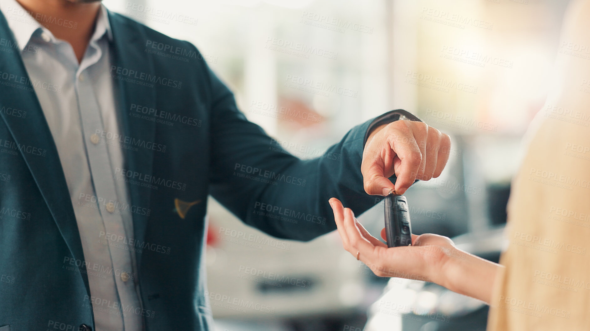 Buy stock photo Showroom, salesman and customer with hands for car keys, test drive or success purchase of motor. Dealership, people or giving equipment in closeup for buying vehicle, rental service or auto by flare
