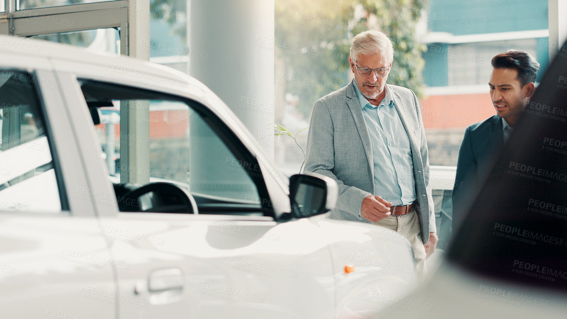 Buy stock photo Car dealership, choice or salesman with customer talking for vehicle history, details or features. Transport, people or person with client in showroom for negotiation, report or decision for purchase