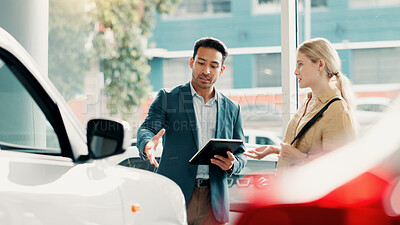 Buy stock photo Tablet, customer and salesman with talking for car dealership, transport model and motor for rental service. Showroom, woman and male seller with tech for assistance, vehicle features and discussion