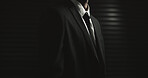 Mafia, space or man in suit on dark or black background in secret mission, mystery and hidden identity. Spy, studio mockup or hitman with tie, assassin style or classic fashion for crime syndicate