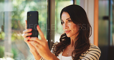 Buy stock photo Home, selfie and mature woman with smile, confident and profile picture for post on website or relax. House, happy and person with memory for social media, calm and photography for self expression